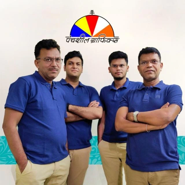 The Panchsheel Graphics team in front of the Panchsheel Graphics logo